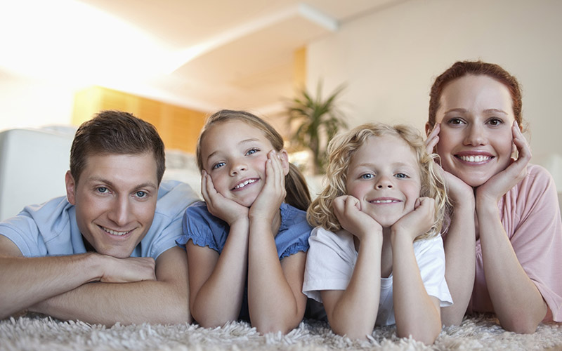happy family lying on carpet