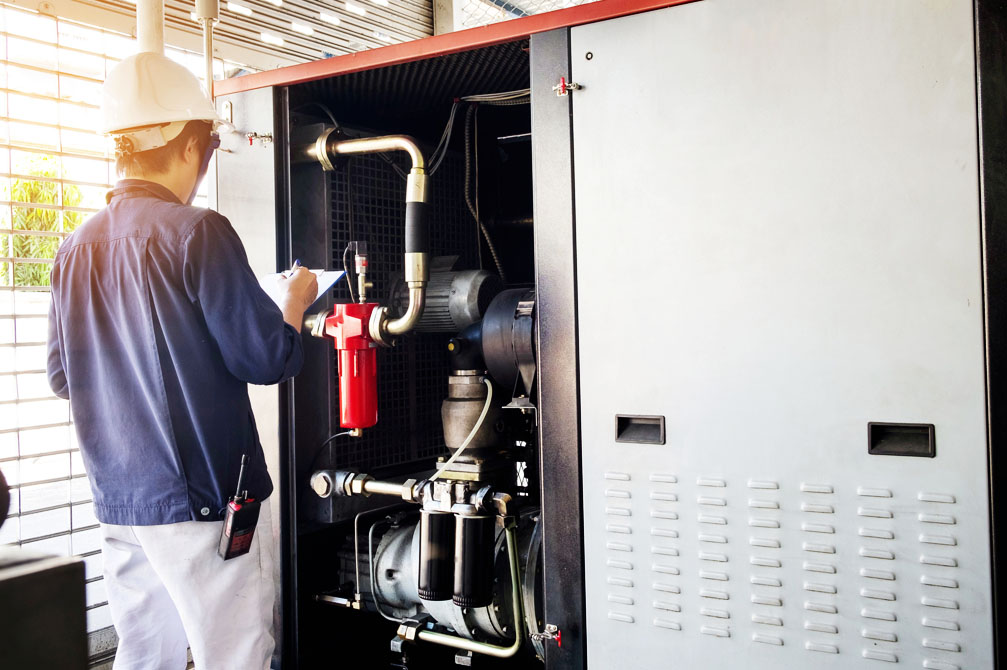Technician diagnosing commercial a/c unit