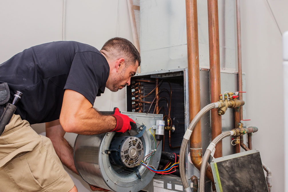 Technician diagnosing a/c unit