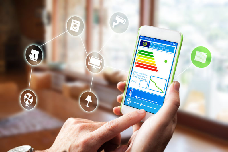 Person using phone with Nexia home automation installed.