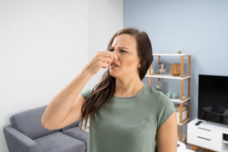 Woman Holding Nose