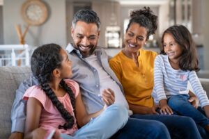 Happy Family Sitting On Couch